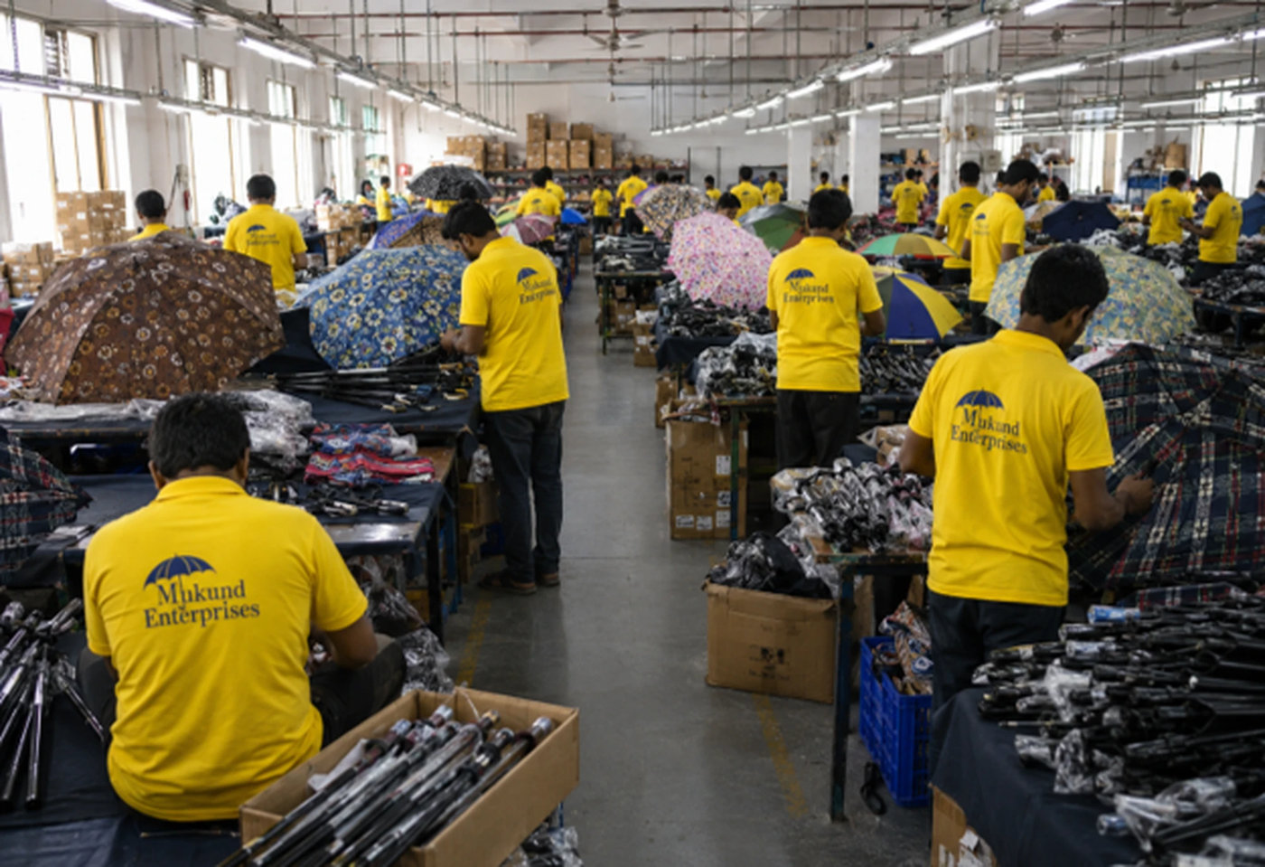Long factory aisle with the team at work on umbrellas